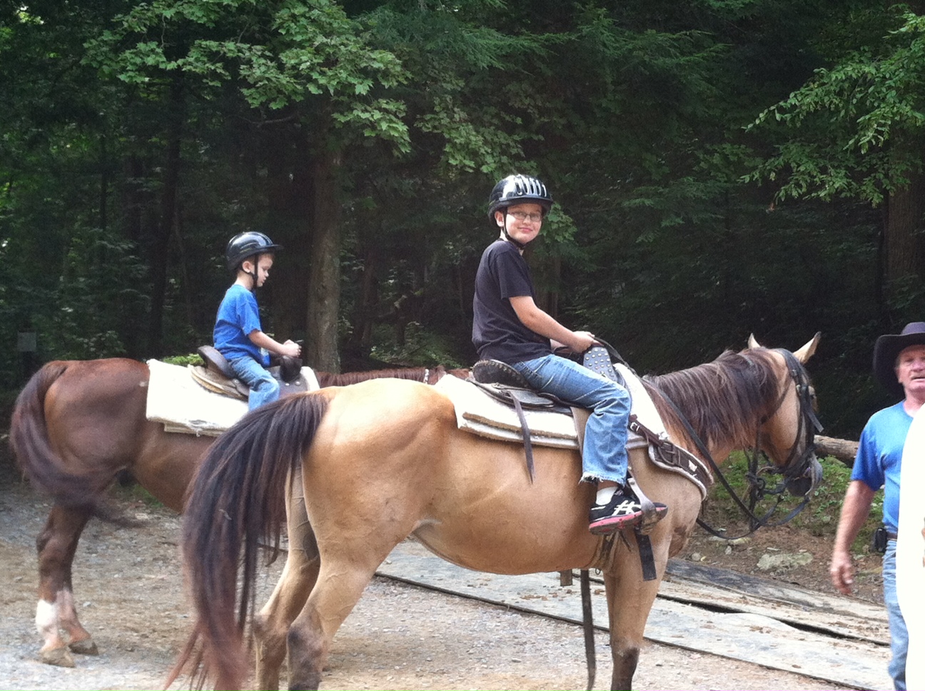 two boys on horseback smiling